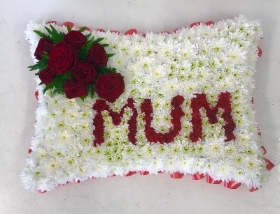 Red pillow with mum in flowers